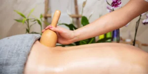 Using Maderotherapy techniques to enhance relaxation, reduce cellulite, and promote lymphatic drainage.